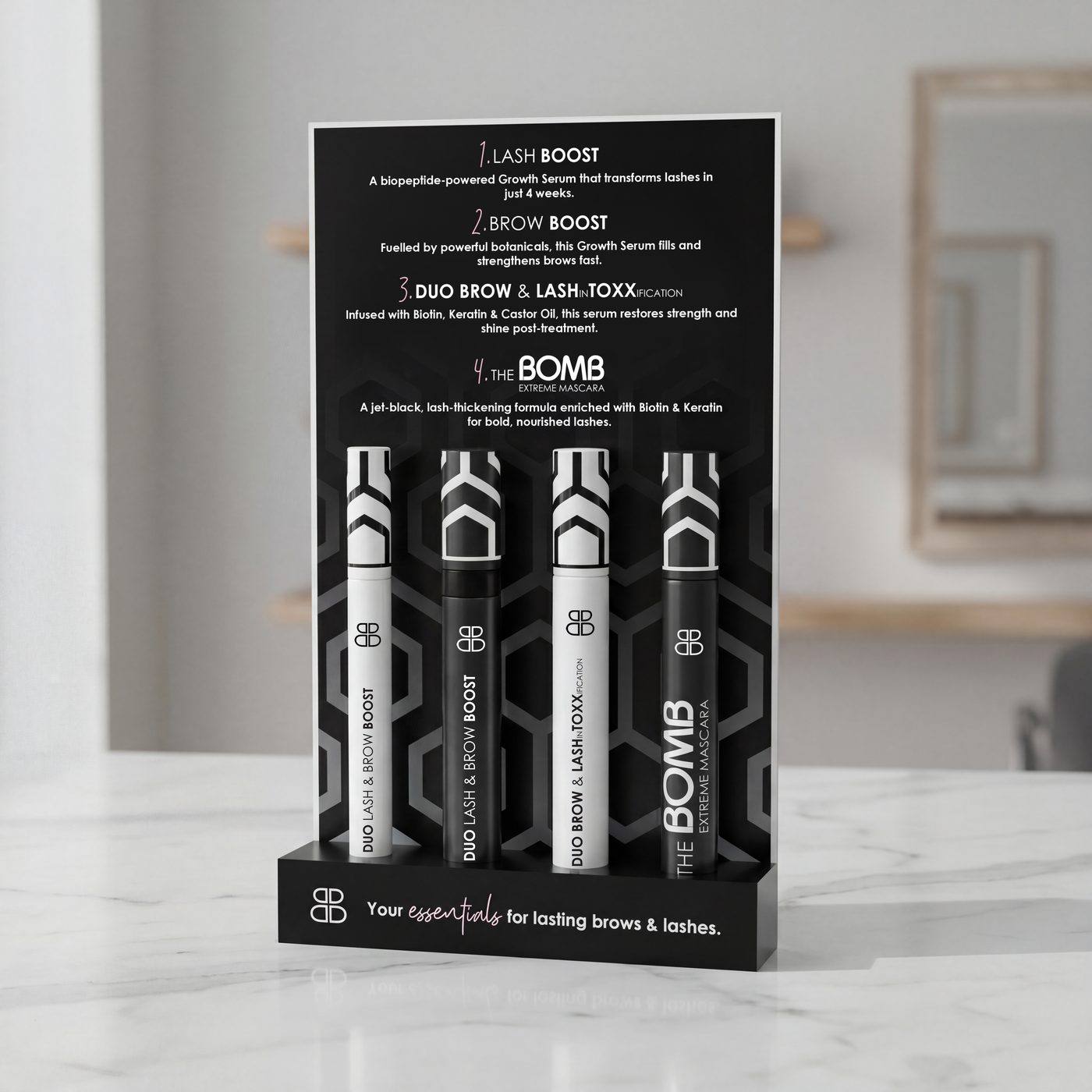 BOMB Duo countertop POS display holding four Lash and Brow Boost and mascara tubes