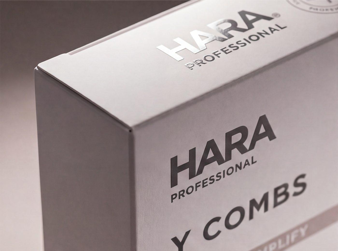 Close-up of the embossed Union Jack heart seal on a HARA Professional box, reading Lash and Brow Enhancing, Designed in the UK