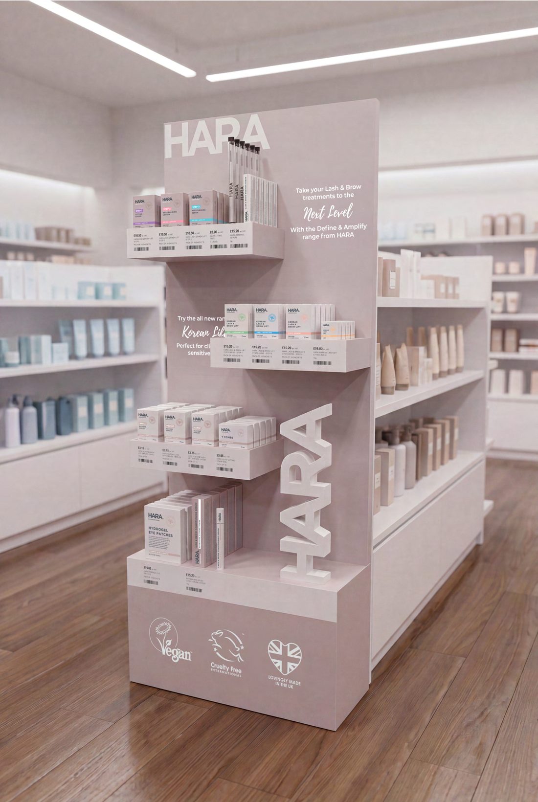 HARA Professional free-standing display unit in a pharmacy, with the range merchandised on staggered shelves and a tall HARA sign