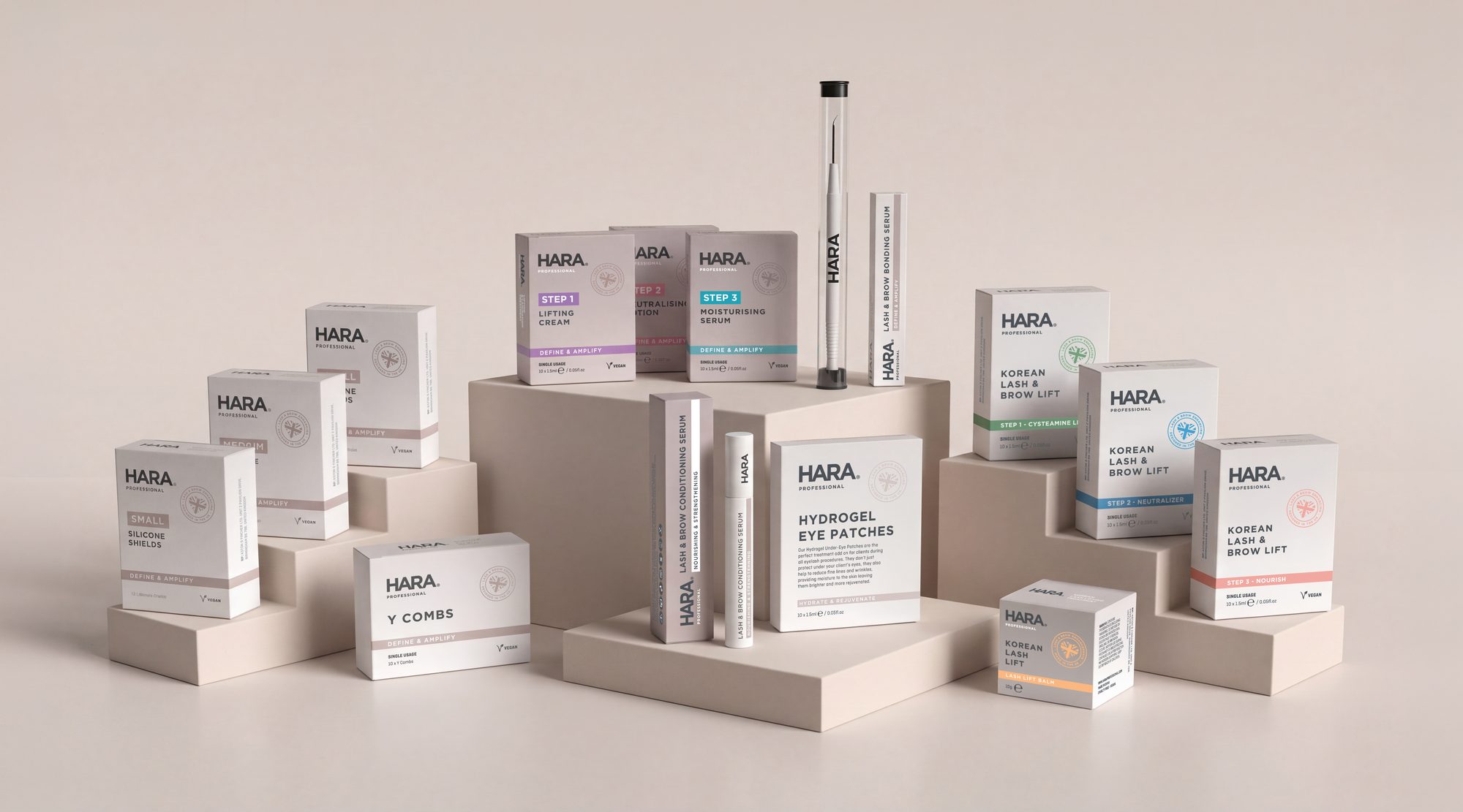 HARA Professional lash and brow packaging range arranged on pale plinths