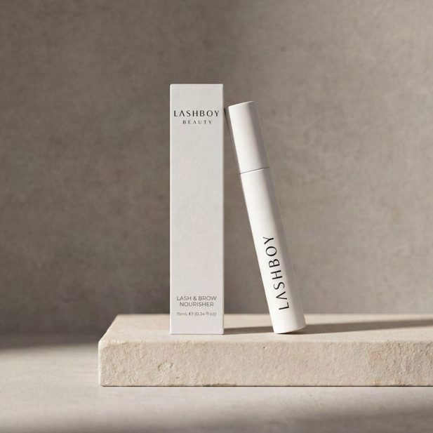 Slim white lash serum carton and tube on a stone plinth